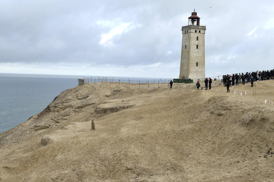 The Rubjerg Knude Lighthouse is being moved in Jutland, Denmark, Tuesday, Oct. 22, 2019. A 120-year-old lighthouse has been put on wheels and rails to attempt to move it some 80 meters (263 feet) away from the North Sea, which has been eroding the coastline of northwestern Denmark. When the 23-meter (76 feet) tall Rubjerg Knude lighthouse was first lit, in 1990, it was roughly 200 meters (656 feet) from the coast; now it is only about 6 meters away. (Henning Bagger/Ritzau Scanpix via AP)