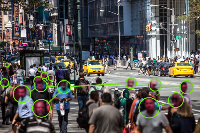 Facial Recognition technology used to prevent Covid-19 spread.  Note for inspectors: people is a crowd, cars are edited even if not necessary.