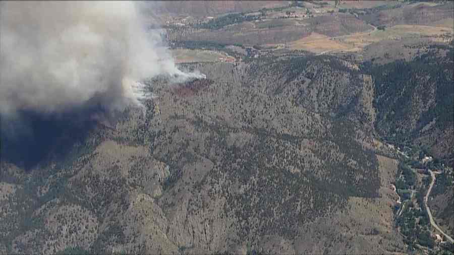 The smoke cloud of the Alexander Mountain Fire is towering over the mountains, visible for miles. This photo from SkyFOX shows the distance to some structures and people in the area.