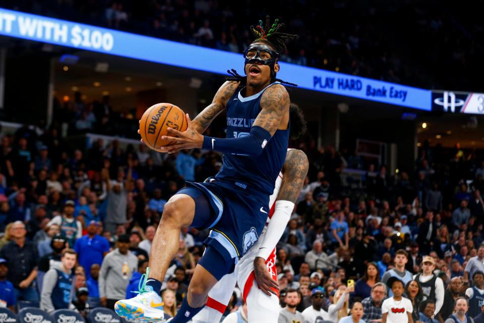 Grizzlies' Ja Morant (12) goes for a layup during the game between the Memphis Grizzlies and the Houston Rockets at FedExForum in Memphis, Tenn., on March 22, 2023.