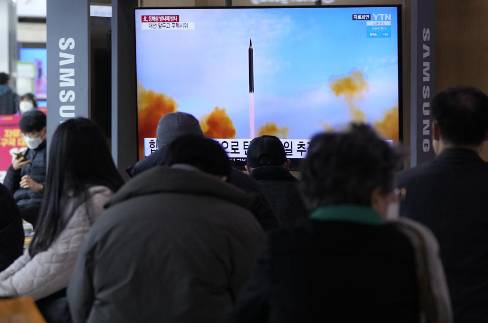 People watch a TV showing a file image of North Korea's missile launch during a news program at the Seoul Railway Station in Seoul, South Korea, Saturday, March 5, 2022. North Korea on Saturday fired a suspected ballistic missile into the sea, according to its neighbors' militaries, apparently extending its streak of weapons tests this year amid a prolonged freeze in nuclear negotiations with the United States. (AP Photo /Ahn Young-joon)