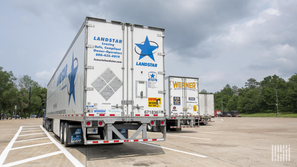 a Landstar tractor-trailer parked next to a Werner rig