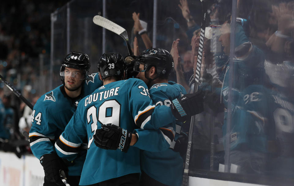 San Jose Sharks' Marc-Edouard Vlasic (44) and Logan Couture (39) celebrate goal by Gustav Nyquist (14), center, against the Colorado Avalanche in the first period of Game 1 of an NHL hockey second-round playoff series at the SAP Center in San Jose, Calif., on Friday, April 26, 2019. (AP Photo/Josie Lepe)