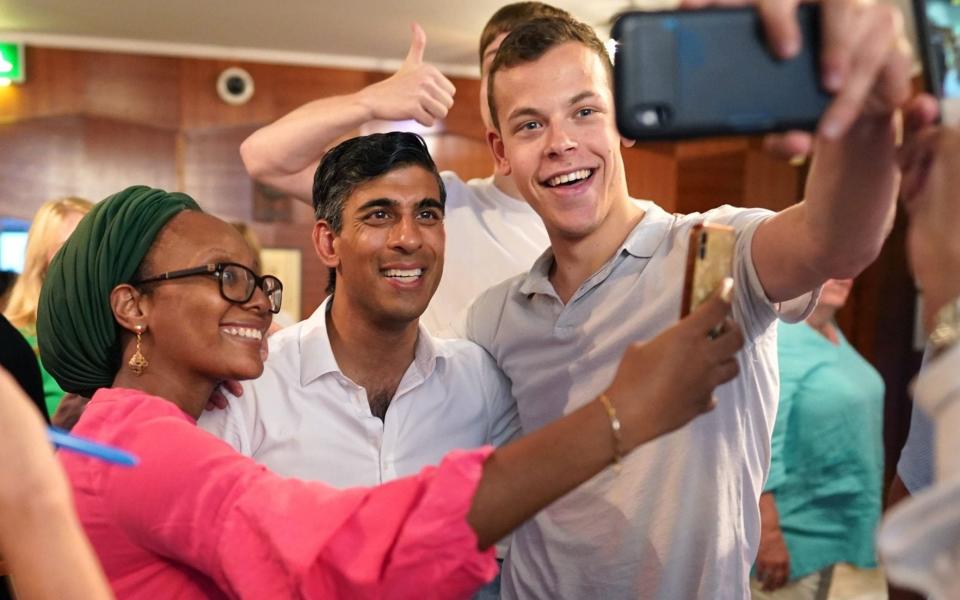 Rishi Sunak posing for selfies during a visit to St John's Wood Synagogue, north London, on Wednesday - Stefan Rousseau/PA wire