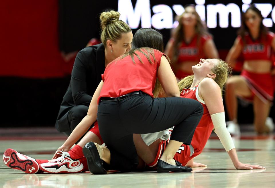 Utah Utes guard Gianna Kneepkens (5) grimaces in pain after being injured at the Huntsman Center in Salt Lake City on Dec. 2, 2023.