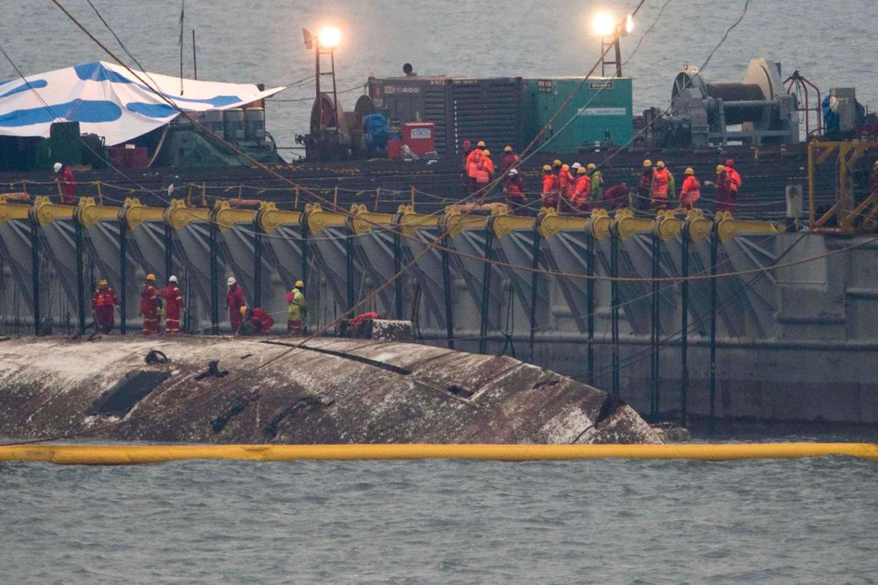 Salvage operation: Workers check on the surface of the damaged Sewol ferry: AFP/Getty Images