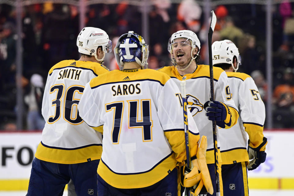 Nashville Predators goaltender Juuse Saros (74) and Matt Duchene, second from right, celebrate after a win in overtime of an NHL hockey game against the Philadelphia Flyers, Saturday, Feb. 11, 2023, in Philadelphia. (AP Photo/Derik Hamilton)