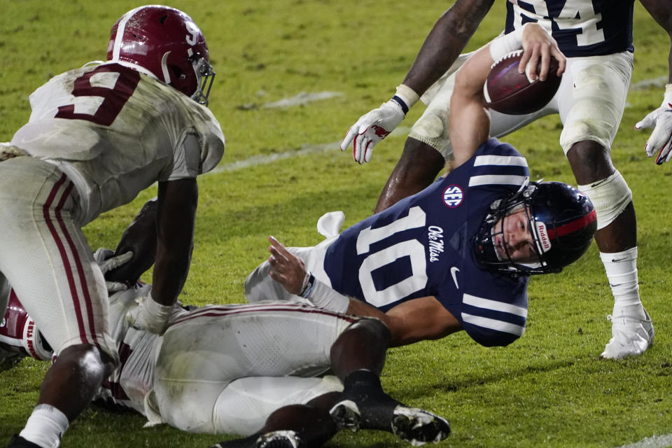Mississippi quarterback John Rhys Plumlee stretches toward the goal line, but is stopped short, as Alabama defensive back Jordan Battle (9) defends during the second half of an NCAA college football game in Oxford, Miss., Saturday, Oct. 10, 2020. Alabama won 63-48. (AP Photo/Rogelio V. Solis)