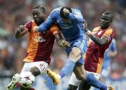 Real Madrid's Cristiano Ronaldo (C) challenges Galatasaray's Aurelien Chedjou (L) and Emmanuel Eboue during their Champions League Group B soccer match at Turk Telekom Arena in Istanbul September 17, 2013. REUTERS/Osman Orsal