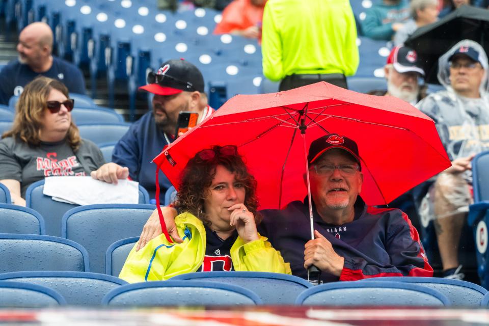 Sep 29, 2024; Cleveland, Ohio, USA; Fans wait in the rain as the game between the Cleveland Guardians and the Houston Astros is delayed at Progressive Field. Mandatory Credit: Ken Blaze-Imagn Images