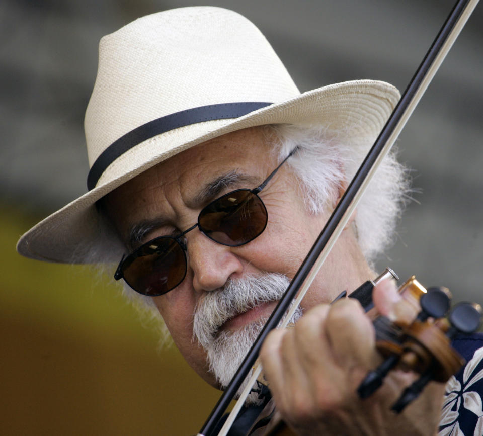 FILE - In this May 1, 2009 file photo, Michael Doucet plays with his cajun band BeauSoliel at the New Orleans Jazz & Heritage Festival in New Orleans. Doucet and his band are performing on Friday, the opening day of this years Jazz Fest, which will run two consecutive weekends from Friday, April 27 until May 6th. (AP Photo/Bill Haber, File)