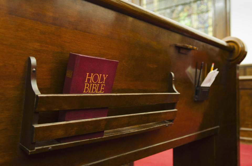 holy bible in the back of a church pew