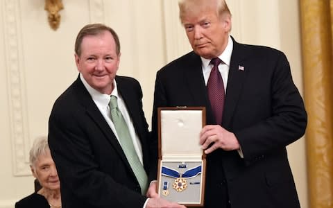 Jack Soden, CEO of Elvis Presley Enterprises, accepts the Presidential medal of Freedom award - Credit: AFP