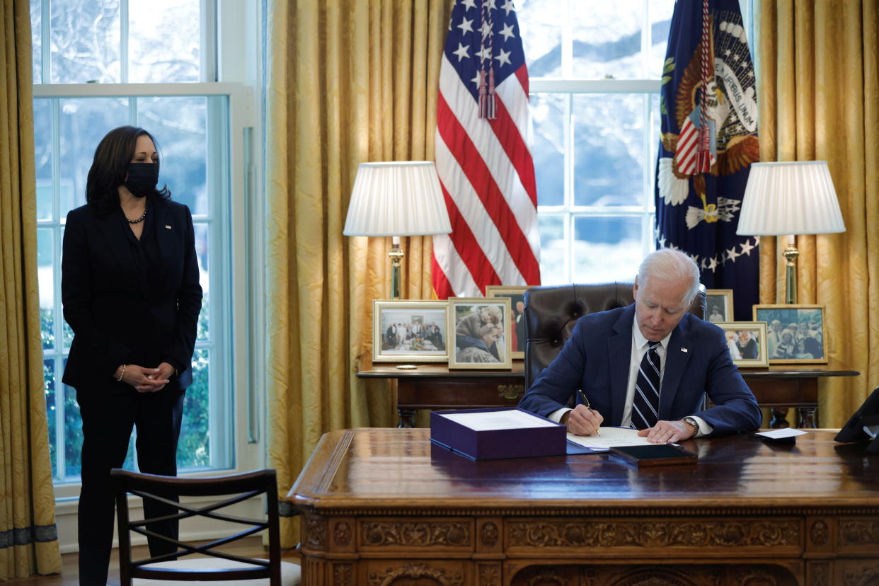 U.S. President Joe Biden signs the American Rescue Plan, a package of economic relief measures to respond to the impact of the coronavirus disease (COVID-19) pandemic, inside the Oval Office at the White House in Washington, U.S., March 11, 2021. REUTERS/Tom Brenner     TPX IMAGES OF THE DAY