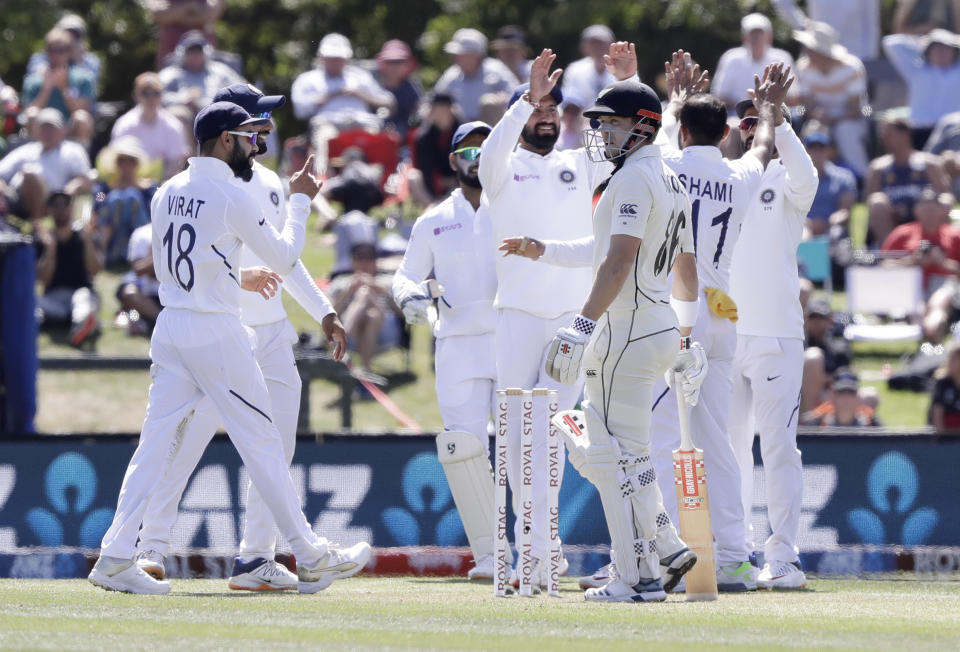 India's Virat Kohli, left, celebrates with his teammates after taking a catch to dismiss New Zealand's Henry Nicholls during play on day two of the second cricket test between New Zealand and India at Hagley Oval in Christchurch, New Zealand, Sunday, March 1, 2020. (AP Photo/Mark Baker)