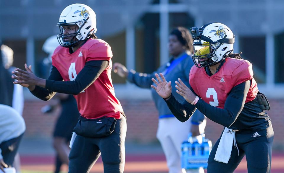 Quarterbacks Zach Sims, left, and Andrew Body take snaps during an Alabama State University football practice on the ASU campus in Montgomery, Ala., on Thursday March 28, 2024.