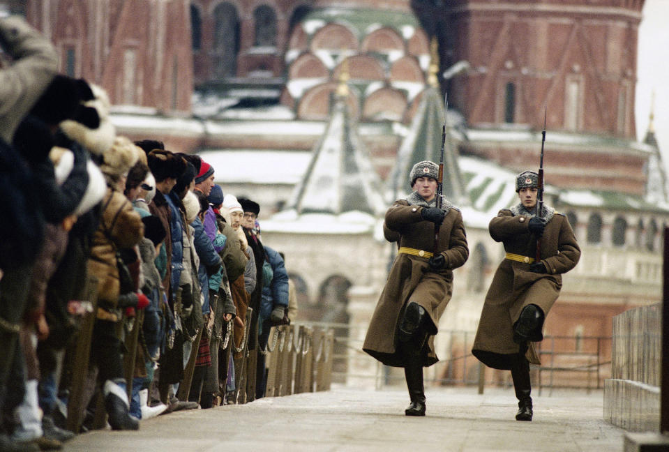 FILE - Soviet citizens watch honors guard soldiers during the changing of the guard at Lenin's Mausoleum in Red Square, Moscow, Russia, on Dec. 11, 1991. On Dec. 8, 1991, the leaders of Russia, Ukraine and Belarus declared the USSR dead and announced the creation of the Commonwealth of Independent States, an alliance joined two weeks later by eight other Soviet republics. (AP Photo/Alexander Zemlianichenko, File)