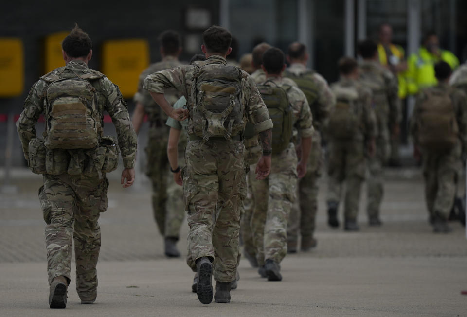Members of the British armed forces 16 Air Assault Brigade walk to the air terminal after disembarking a RAF Voyager aircraft at Brize Norton, England, as they return from helping in operations to evacuate people from Kabul airport in Afghanistan, Saturday, Aug. 28, 2021. More than 100,000 people have been safely evacuated through the Kabul airport, according to the U.S., but thousands more are struggling to leave in one of history's biggest airlifts. (AP Photo/Alastair Grant, Pool)