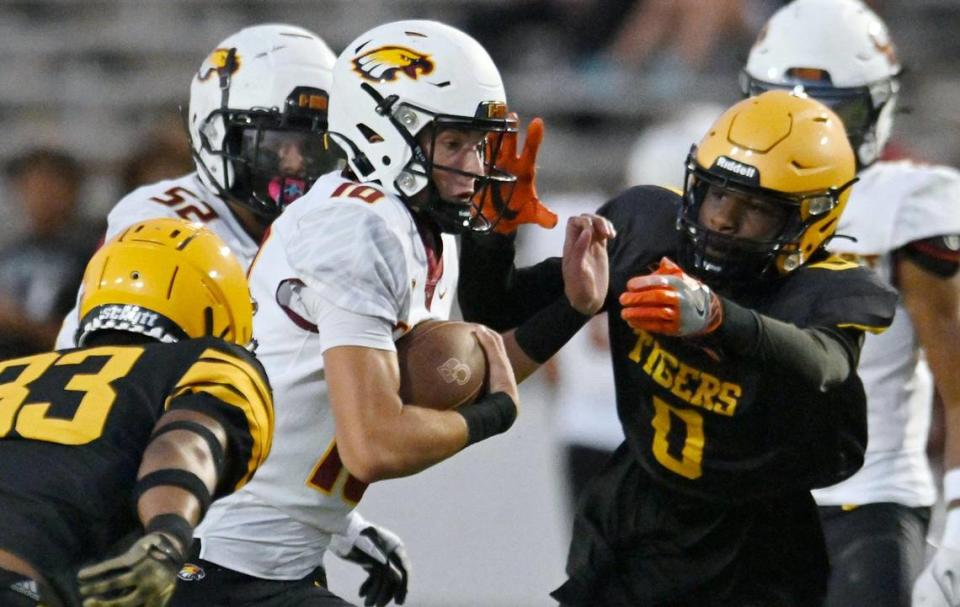 Clovis West quarterback Tyler Franklin, center, finds an opening as he scrambles against Edison Friday, Sept. 15, 2023 in Fresno. ERIC PAUL ZAMORA/ezamora@fresnobee.com