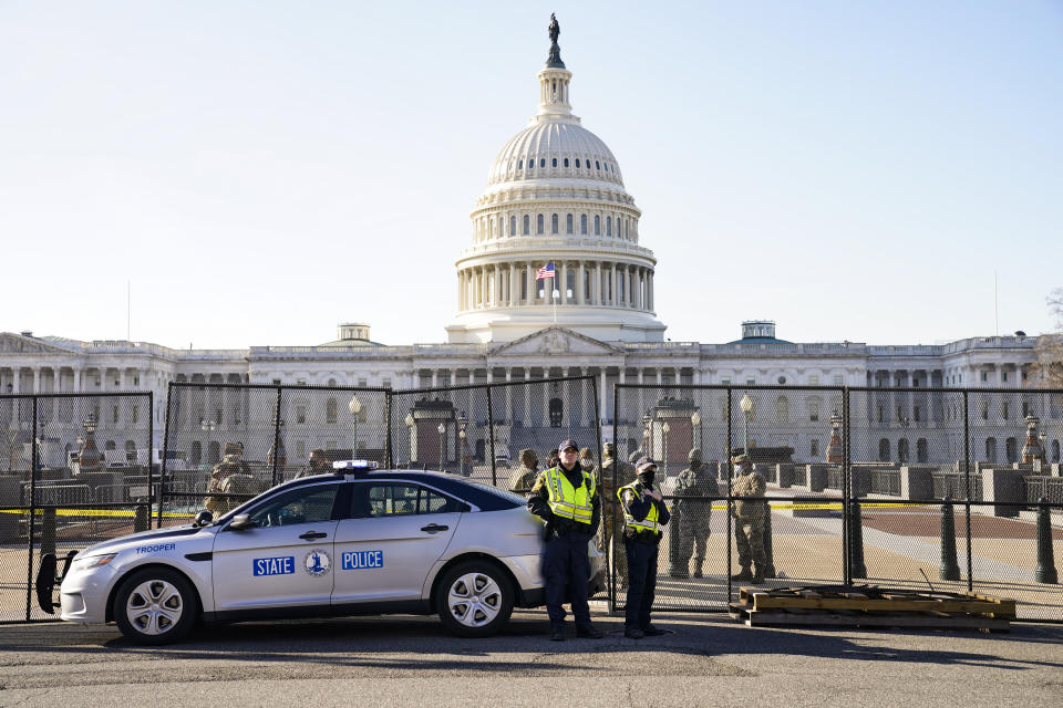 Fencing is placed around the exterior of the Capitol grounds, Thursday morning, Jan. 7, 2021 in Washington. The House and Senate certified the Democrat's electoral college win early Thursday after a violent throng of pro-Trump rioters spent hours Wednesday running rampant through the Capitol. A woman was fatally shot, windows were bashed and the mob forced shaken lawmakers and aides to flee the building, shielded by Capitol Police. (AP Photo/John Minchillo)