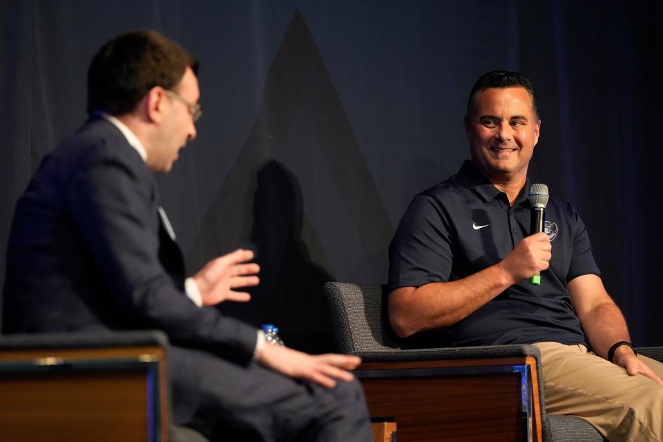Xavier Musketeers men’s basketball head coach Sean Miller (right) joins sports commentator Jason Benetti on stage during a Xavier University basketball preseason preview event at the Cintas Center in Cincinnati on Monday, Oct. 2, 2023.