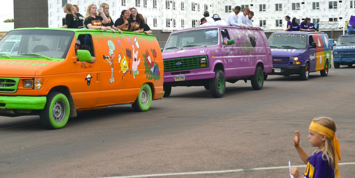Watertown high-schoolers rock and bounce the parade vans they painted for this year's homecoming parade, which was on Friday.