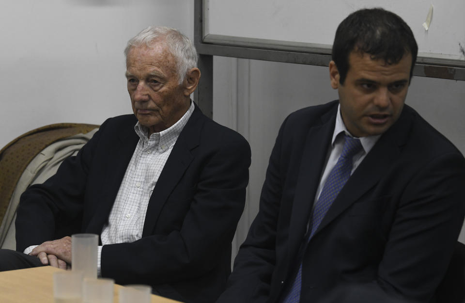 Former Ford Motor Co. executive Pedro Muller, left, who is charged with crimes against humanity for allegedly targeting Argentine union workers for kidnapping and torture after the country's 1976 military coup, awaits sentencing in Buenos Aires, Argentina, Tuesday, Dec. 11, 2018. (AP Photo/Gustavo Garello)