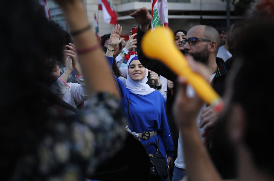 Lebanese protesters shout slogans as they march in Beirut, Lebanon, Sunday, Dec. 1, 2019. Protesters have been holding demonstrations since Oct. 17 demanding an end to widespread corruption and mismanagement by the political class that has ruled the country for three decades. (AP Photo/Hussein Malla)