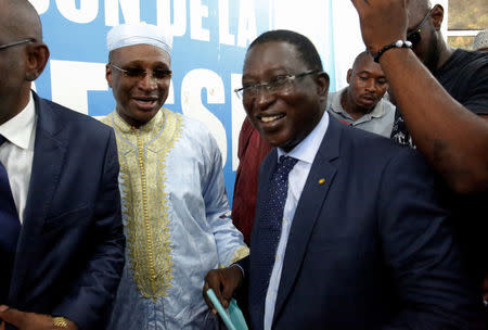 Soumaila Cisse, leader of opposition party URD (Union for the Republic and Democracy), walks with Aliou Diallo, leader of the Democratic Alliance for Peace (Alliance Democratique pour la Paix, or ADP-MALIBA) party, after attending a joint news conference of opposition candidates in Mali's presidential election in Bamako, Mali August 1, 2018. REUTERS/Luc Gnago