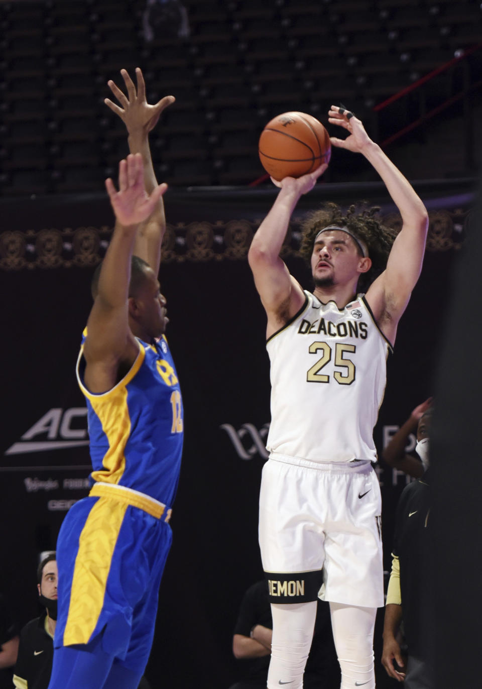 Wake Forest's Ismael Massoud sinks a 3-point shot over Pittsburgh's Abdoul Karim Coulibaly during an NCAA college basketball game Saturday, Jan. 23, 2021, in Winston-Salem, N.C. (Walt Unks/The Winston-Salem Journal via AP)