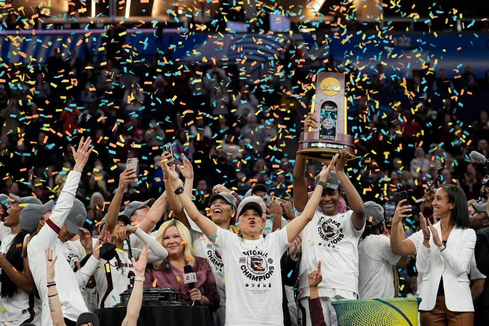 South Carolina head coach Dawn Staley celebrates with her team after a college basketball game in the final round of the Women's Final Four NCAA tournament against UConn in 2022. The number of women competing at the highest level of college athletics continues to rise along with an increasing funding gap between men's and women's sports programs, according to an NCAA report examining the 50th anniversary of Title IX.