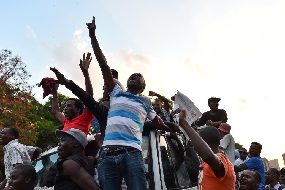 People celebrate in the streets of Harare.