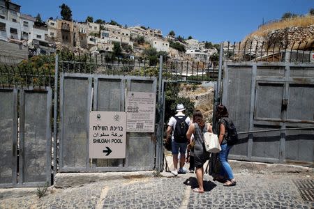 Visitors enter Shiloah Pool, part of an archaeological site known as a the City of David, still an active dig and also a tourist attraction, situated close to Silwan, a Palestinian neighbourhood next to Jerusalem's Old City June 30, 2016. REUTERS/Ammar Awad