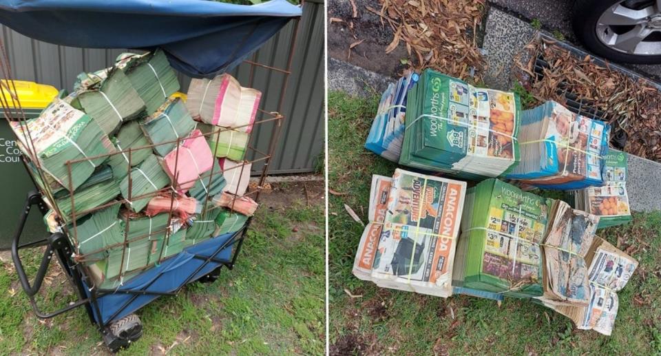 Towering stacks of dumped retail catalogues in alley.