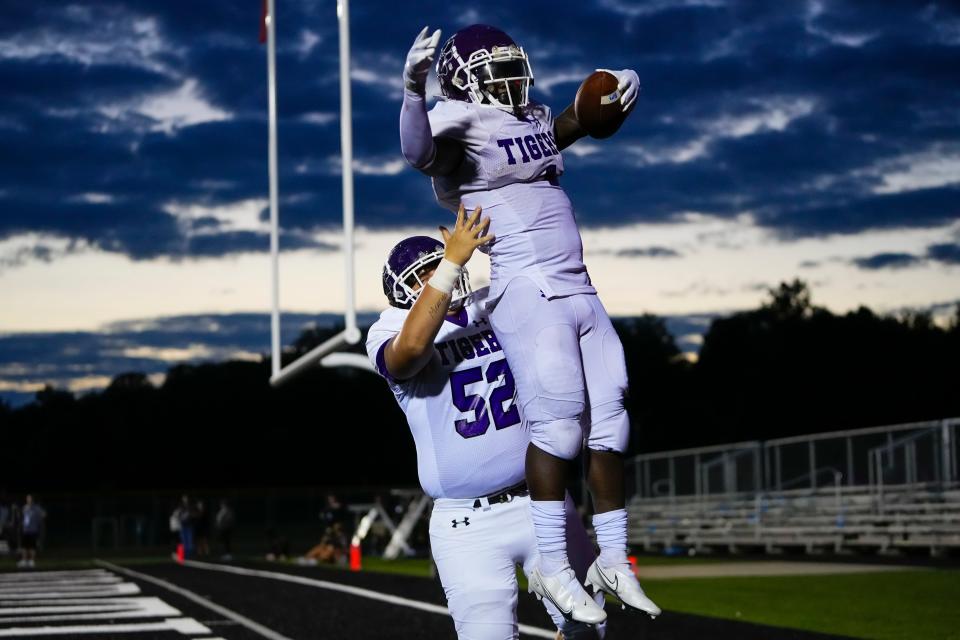 Pickerington Central running back Aaron Heller celebrates a touchdown with offensive lineman Austin DiNardo (52) during a game Sept. 8 at Pickerington North.