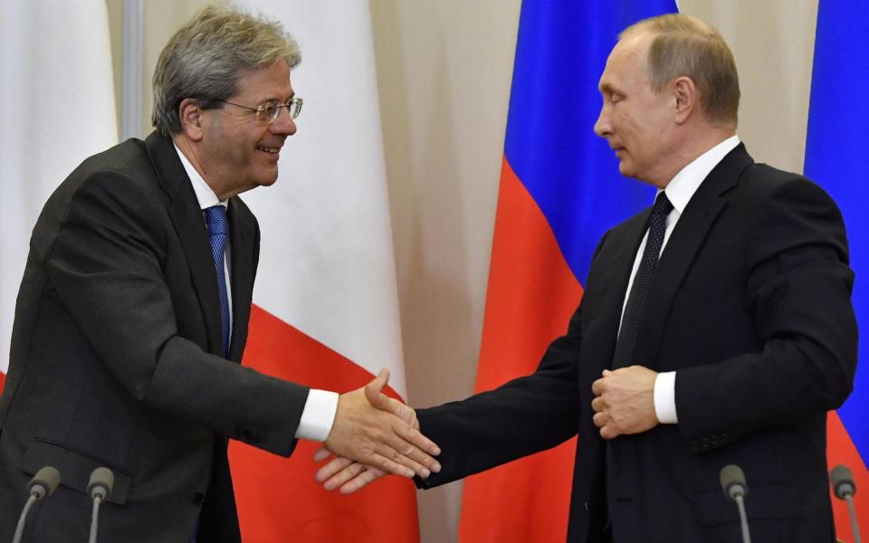 Russian President Vladimir Putin, right, and Italian Prime Minister Paolo Gentiloni attend a joint news conference at the Bocharov Ruchei state residence in Russian Black Sea resort of Sochi on Wednesday, May 17, 2017. - Credit: Yuri Kadobnov/ POOL AFP