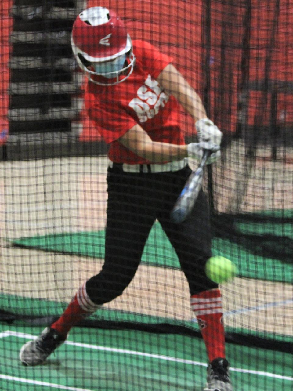 Divine Savior Holy Angels Mia Jensen takes a swing in the batting cage during the team's first practice of the season on Monday April 19, 2021 at DSHA High School in Milwaukee, Wis.