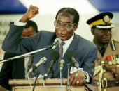 <p>Mugabe gives a speech concerning land resettlement during the Third National People’s Conference at Mary Mount Teachers’ College in Mutare, Zimbabwe, in 1997. (Photo: C. Collingridge/AP) </p>