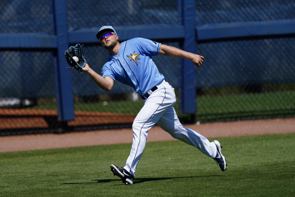 Tampa Bay Rays left fielder Austin Meadows (17) makes a running catch on a fly ball hit by Minnesota Twins' Luis Arraez in the third inning of a spring training baseball game Saturday, March 13, 2021, in Port Charlotte, Fla.. (AP Photo/John Bazemore)