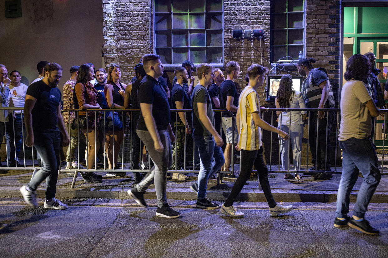 LONDON, ENGLAND - JULY 19: People queue to get in to the Egg London nightclub in the early hours of July 19, 2021 in London, England. As of 12:01 on Monday, July 19, England will drop most of its remaining Covid-19 social restrictions, such as those requiring indoor mask-wearing and limits on group gatherings, among other rules. These changes come despite rising infections, pitting the country's vaccination programme against the virus's more contagious Delta variant. (Photo by Rob Pinney/Getty Images)