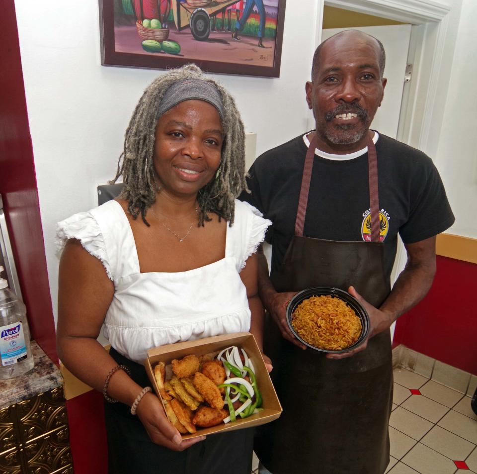 Brockton based Haitian/Signature Restuarant owners and husband and wife, Marline and Genald Amedee, show fried pork and Haitian rice dishes on Tuesday, June 27, 2023. 