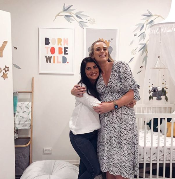 A photo of Sylvia Jeffreys and Anita Birges sharing a hug in her unborn son's nursery room.