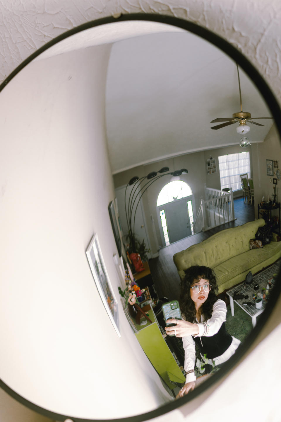 Mercedes Jiménez-Cortés se toma una autofoto con un espejo de tráfico en su casa de Decatur, Georgia, el 14 de enero de 2023. (Marilyne Moja Mwangi/The New York Times)