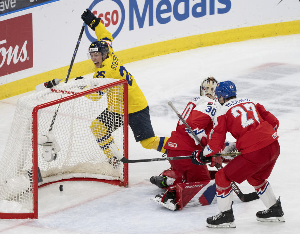 Sweden's Otto Stenberg (25) celebrates a goal by teammate Sweden's Theo Lindstein (not shown) in front of Czechia goaltender Michael Hrabal (30) and Marek Alscher (27) during the first period of a semifinal hockey game at the IIHF World Junior Hockey Championship in Gothenburg, Sweden, Thursday Jan. 4, 2024. (Christinne Muschi/The Canadian Press via AP)