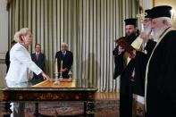 Vassiliki Thanou (left) is sworn in as Greek prime minister at the presidential mansion in Athens on August 27, 2015