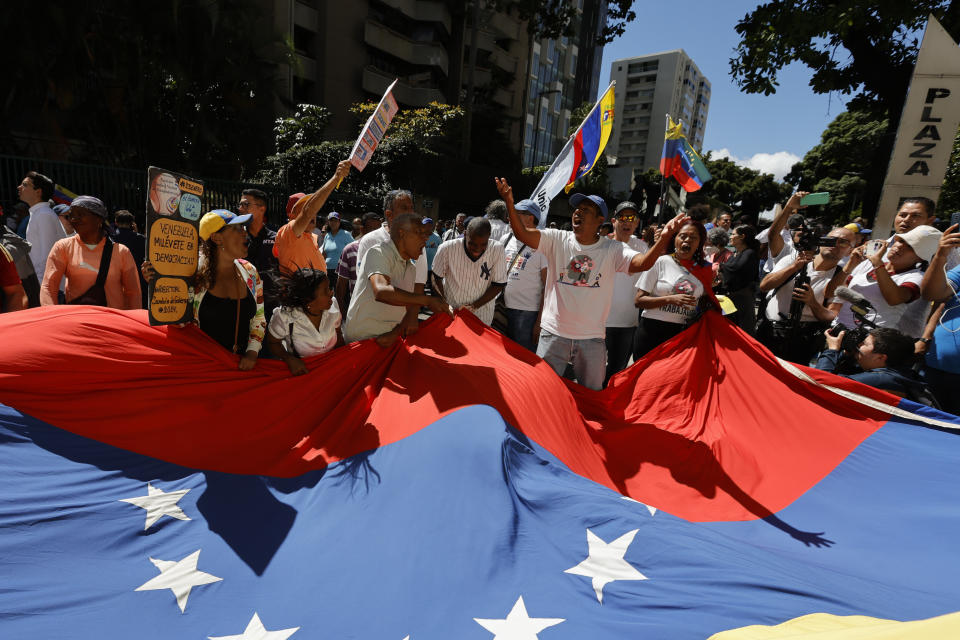 Supporters of opposition coalition presidential hopeful Maria Corina Machado attend her campaign event in Caracas, Venezuela, Tuesday, Jan. 23, 2024. An election date has not been set yet, when the opposition's one candidate, Machado, will run against current President Nicolas Maduro. (AP Photo/Jesus Vargas)