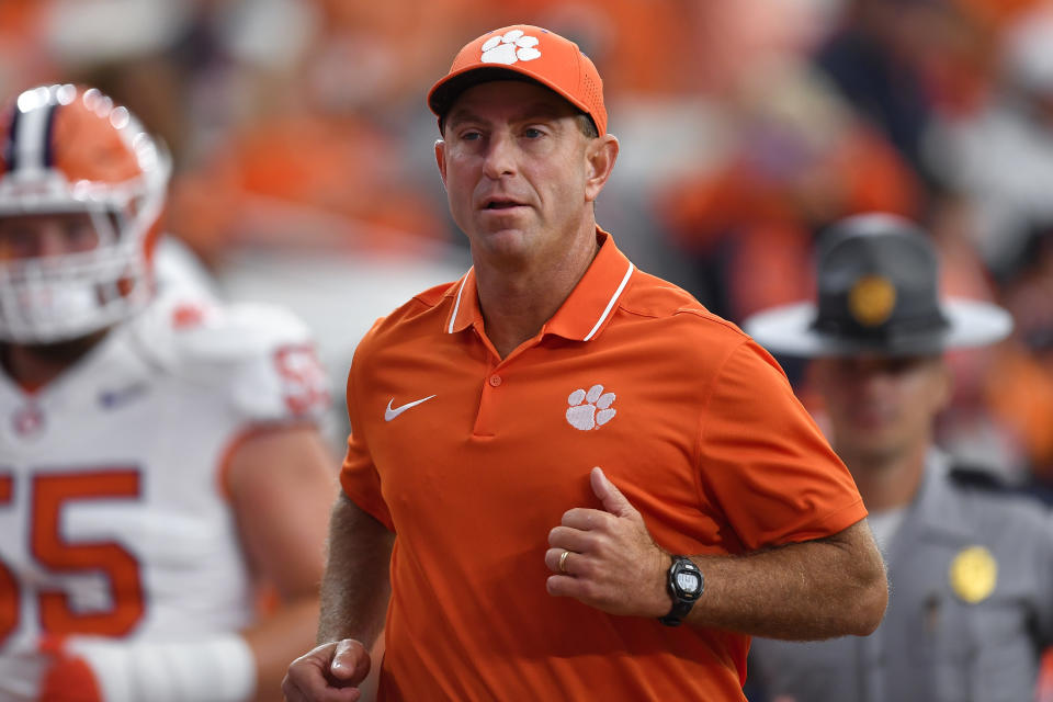 Clemson head coach Dabo Swinney runs on the field during the first half of an NCAA college football game against Syracuse in Syracuse, N.Y., Saturday, Sept. 30, 2023. (AP Photo/Adrian Kraus)