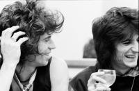 <p>The Rolling Stones bandmates, Keith Richards and Ronnie Wood, laugh over drinks backstage at Madison Square Garden in 1979. </p>