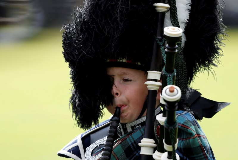 FILE PHOTO: A young piper plays at the annual Braemar Highland Gathering in Braemar, Scotland