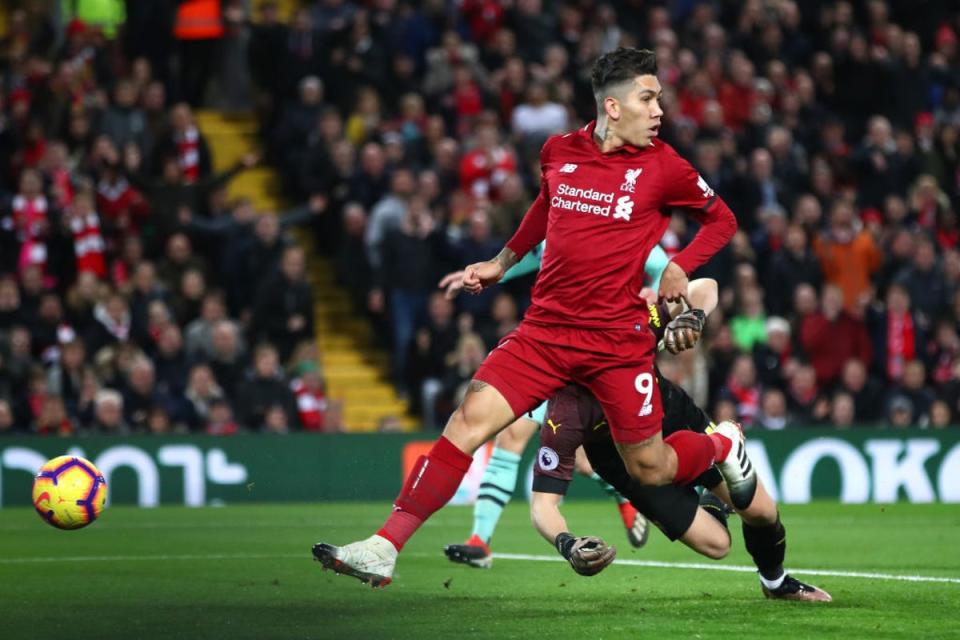 Firmino scores with a trademark ‘no-look’ finish against Arsenal in December 2018 - his favourite Liverpool game (Getty Images)